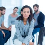 Woman comforting another in rehab group at a therapy session