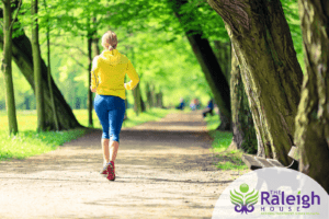 Woman jogging in the park and experiencing the benefits of exercise in recovery