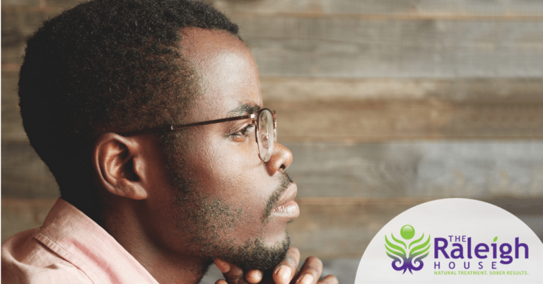 A man with glasses in deep thought