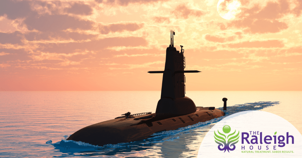 A naval submarine set against an evening sky.