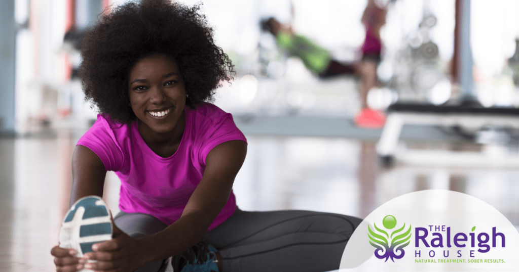 A woman happily works out.