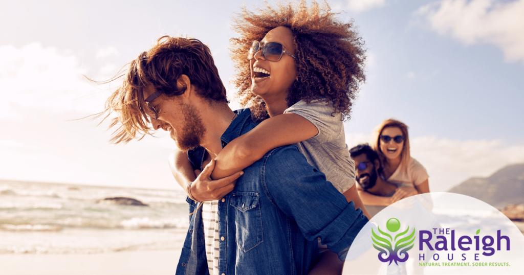 Four friends enjoy socializing on the beach.