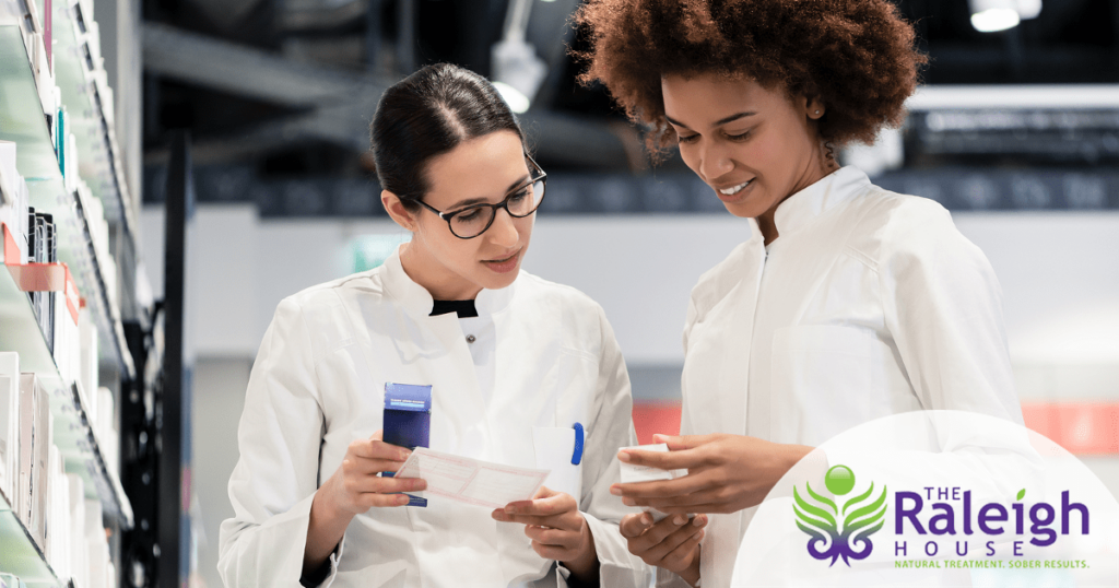 Two pharmacists examine some medication.