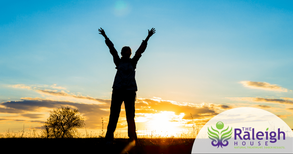 The silhouette of a woman against the backdrop of a dramatic sunset.