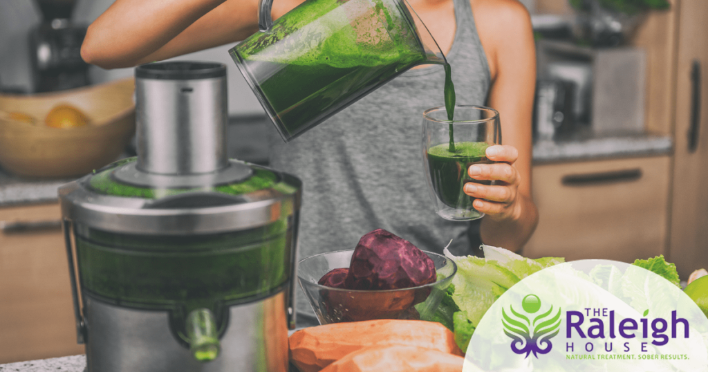 A woman makes a drink in a juicer. 