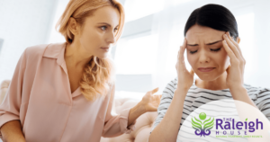 A young woman with an upset look on her face talks to a therapist.