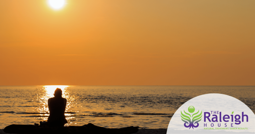 A woman sits alone on an empty Florida beach.