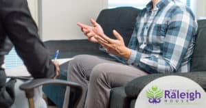 A man speaking to a therapist as part of a social detox program. 