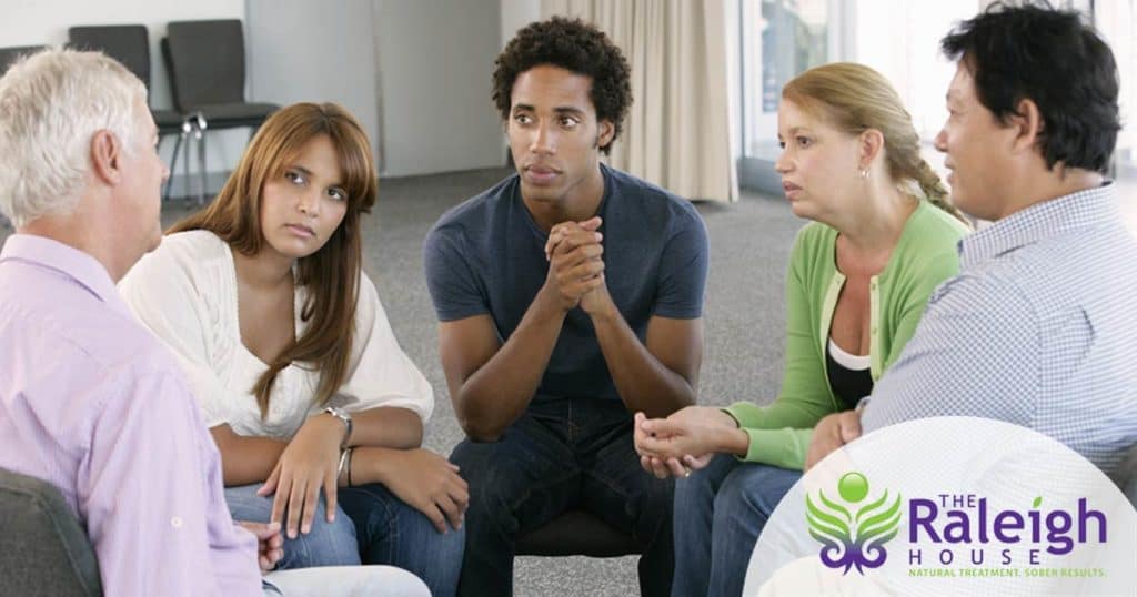 Five people gather for a support group.