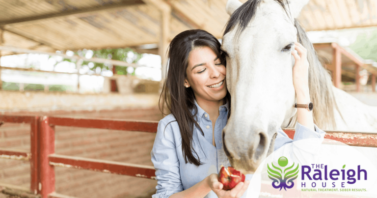 Caucasian woman hugging a horse, emphasizing the role of equine therapy in addiction recovery.