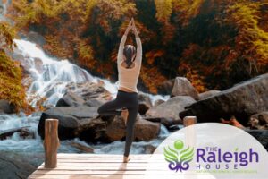 Woman doing yoga and meditation outside in nature to aid her addiction recovery.