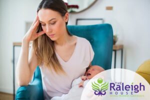 A woman trying to take care of and connect with her newborn while suffering from postpartum depression.
