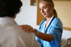 A female nurse comforting a patient going through medically supervised detox.