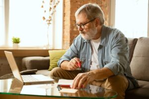 A man in addiction recovery keeping himself busy throughout the day by taking an online class.