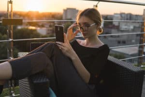 A woman skimming the addiction recovery app and connecting with others who have struggled with addiction.