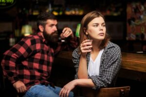 A woman struggling with her alcohol abuse at a bar. 