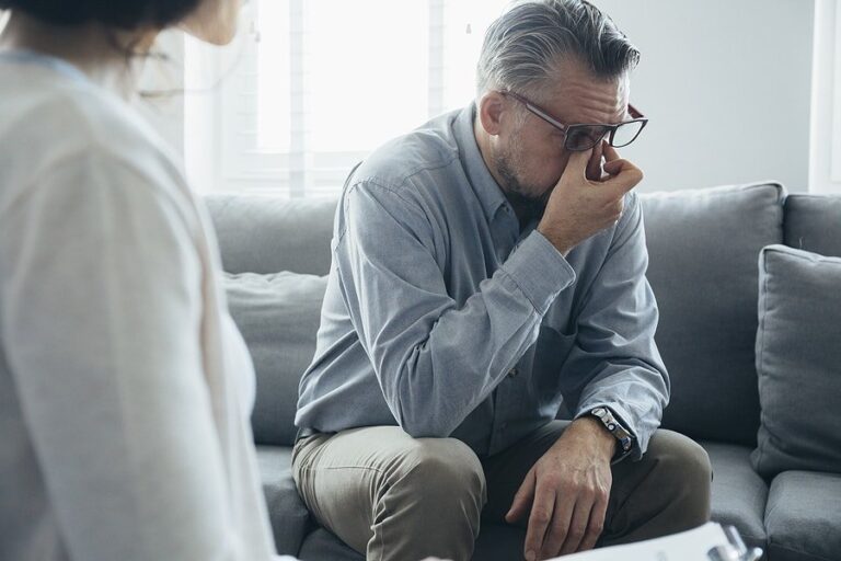 A man talking about his adoption trauma with a therapist.