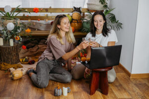 A woman in recovery celebrating Thanksgiving with a loved one in person and other family through video chat.