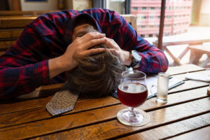 A man struggling with alcohol abuse at home.