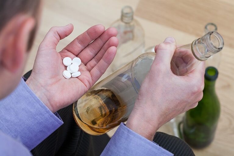 A man mixing psychiatric drugs with alcohol at home.