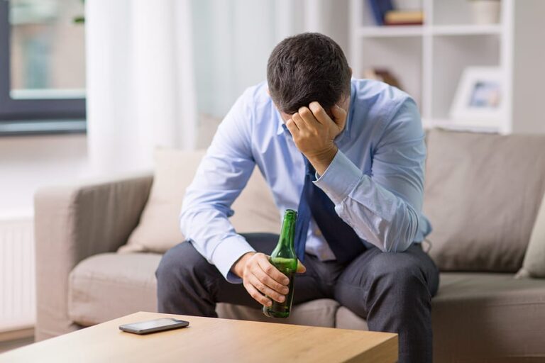 A businessman with a bottle feels overwhelmed by his relapse.
