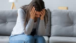 A woman with an anxiety disorder goes through an anxiety attack on the couch.