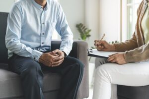 A man talking to a therapist about the best residential treatment option.