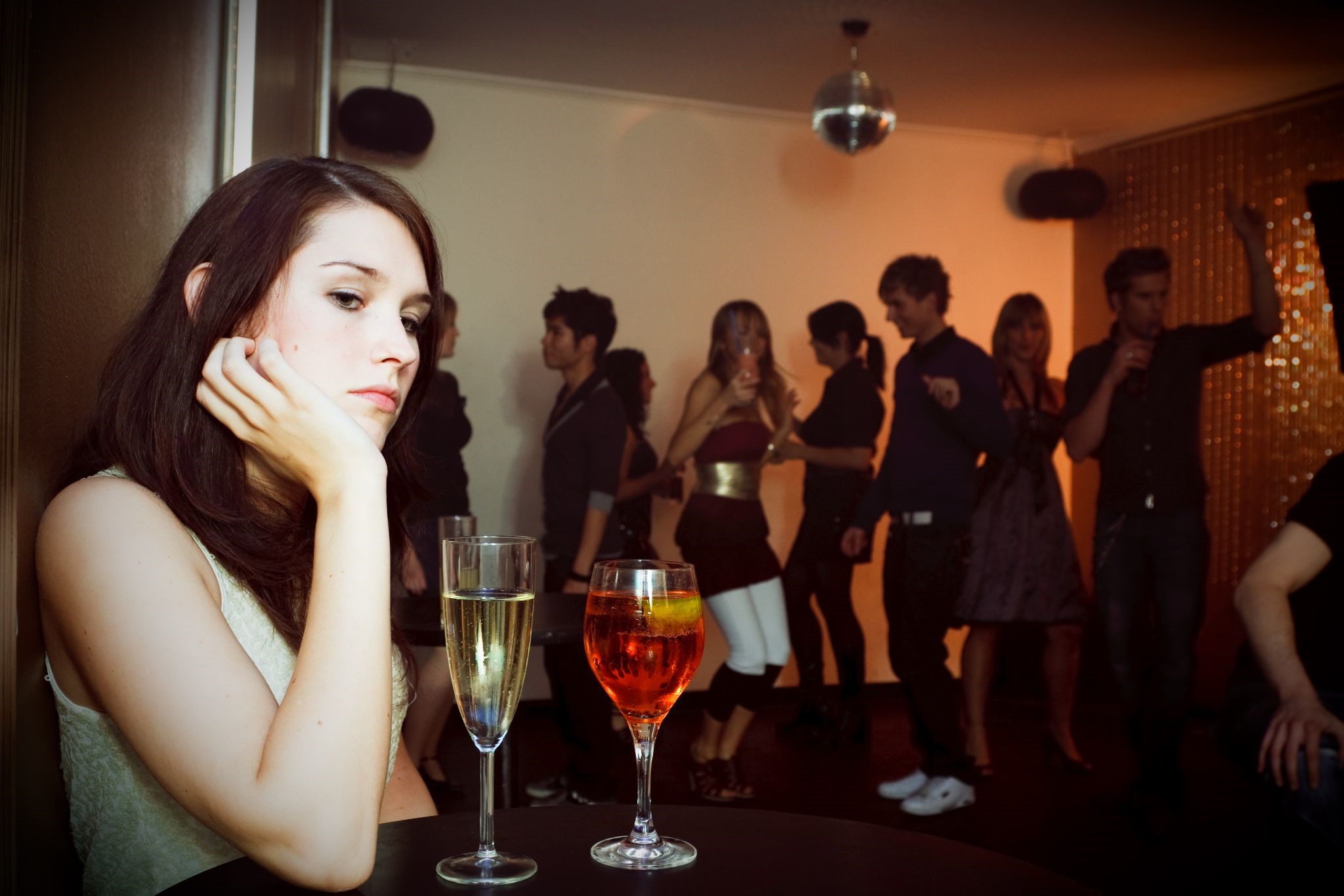 Woman at a party looking depressed