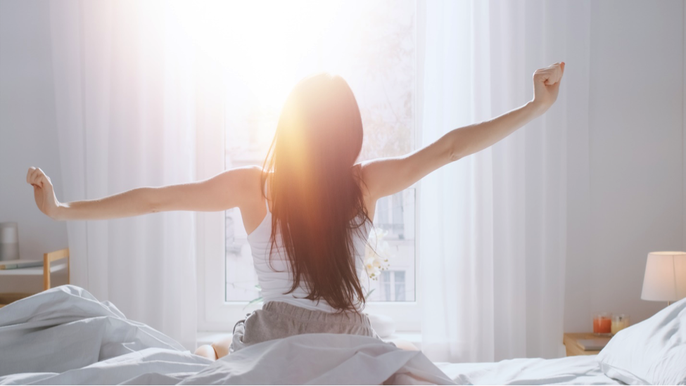 woman waking from sleep in the morning light