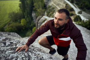 Young man climbing rocks