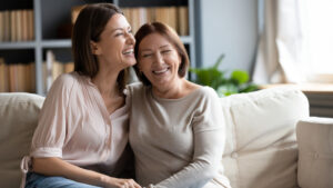 Adult child and mother happily talking