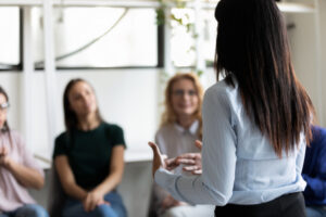 corporate staff gathered together listening rehab center leadership