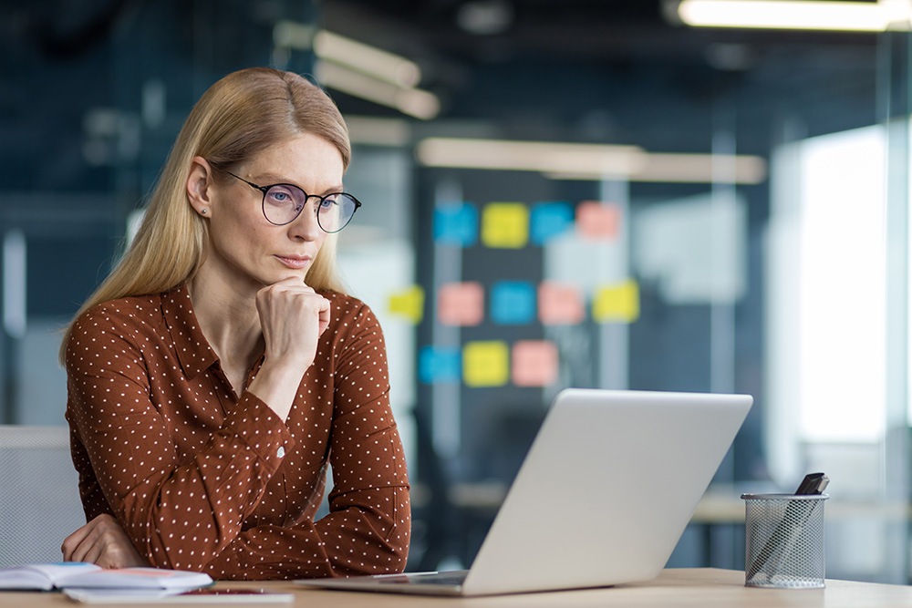 professional woman at work in front of laptop