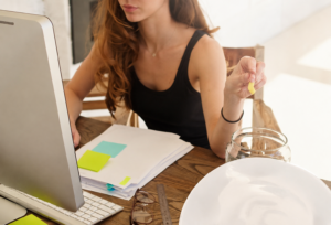 A woman recovering from alcoholism is snacking on sugar to help her cope with work stress.