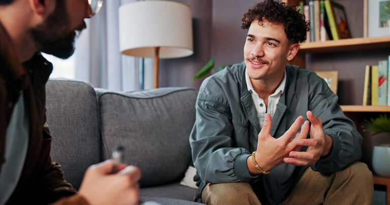 Man sitting on couch with therapist