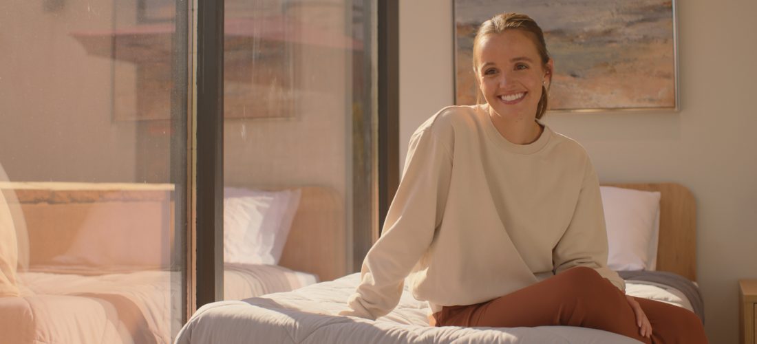 Happy young woman in a bedroom