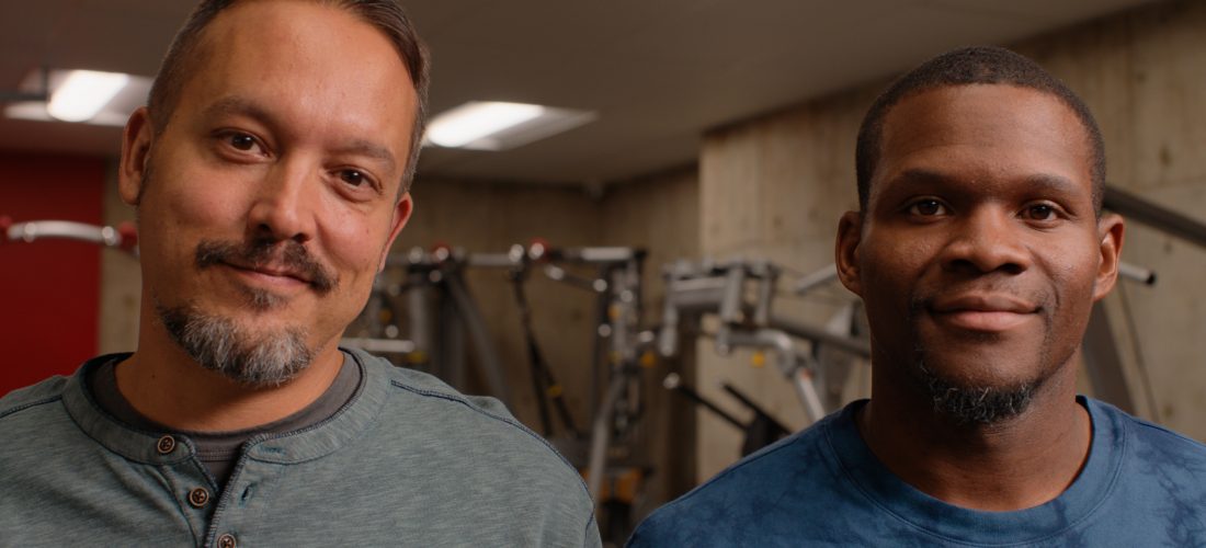 close up of 2 men in a gym